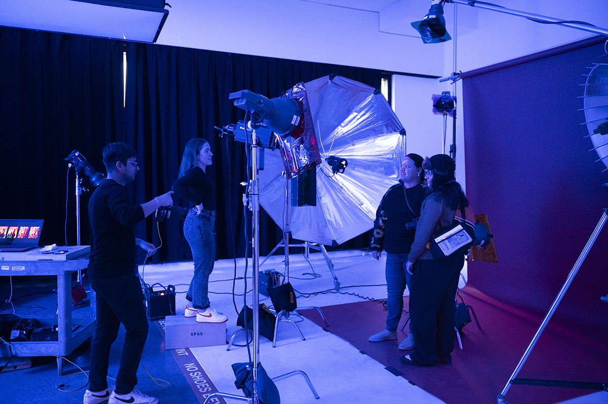 Photo students photograph two subjects in a photo studio at RIT.